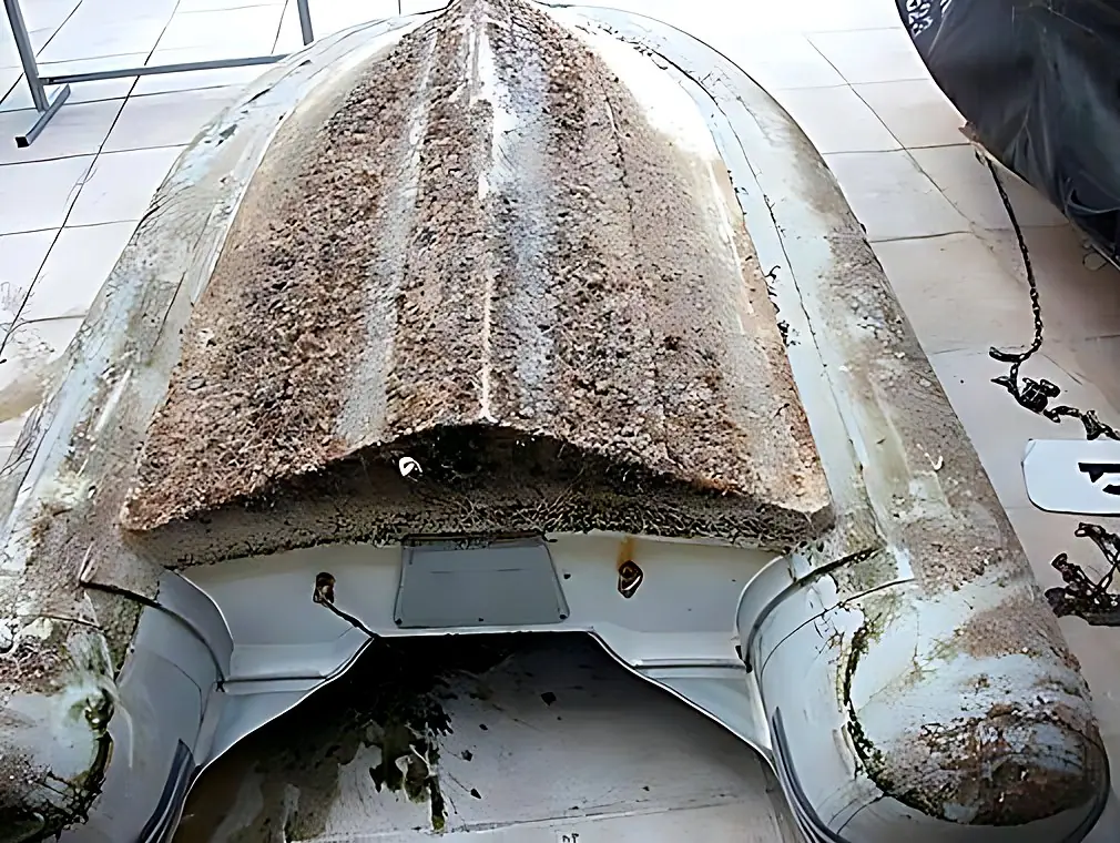 Tube and hull cleaning on a Neptune inflatable boat, before